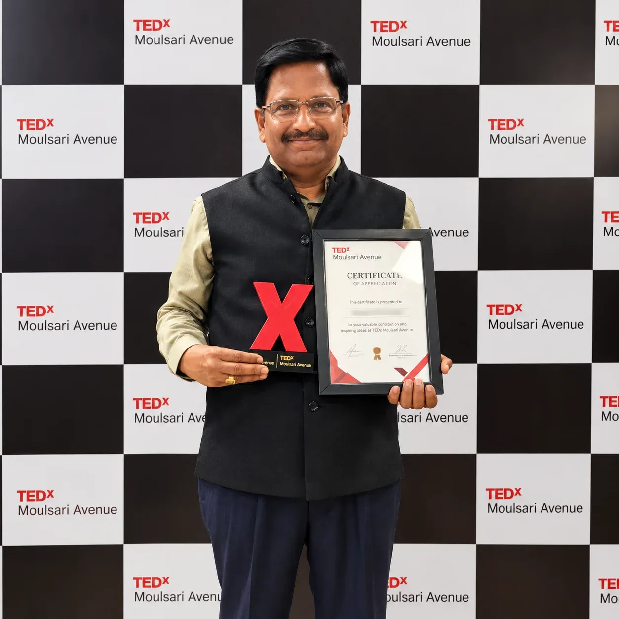 Yennam Srinivas Reddy holding his TEDx Moulsari Avenue speaker certificate
